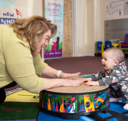 A pre-school teacher playing with a child in this example of phography for non-profits